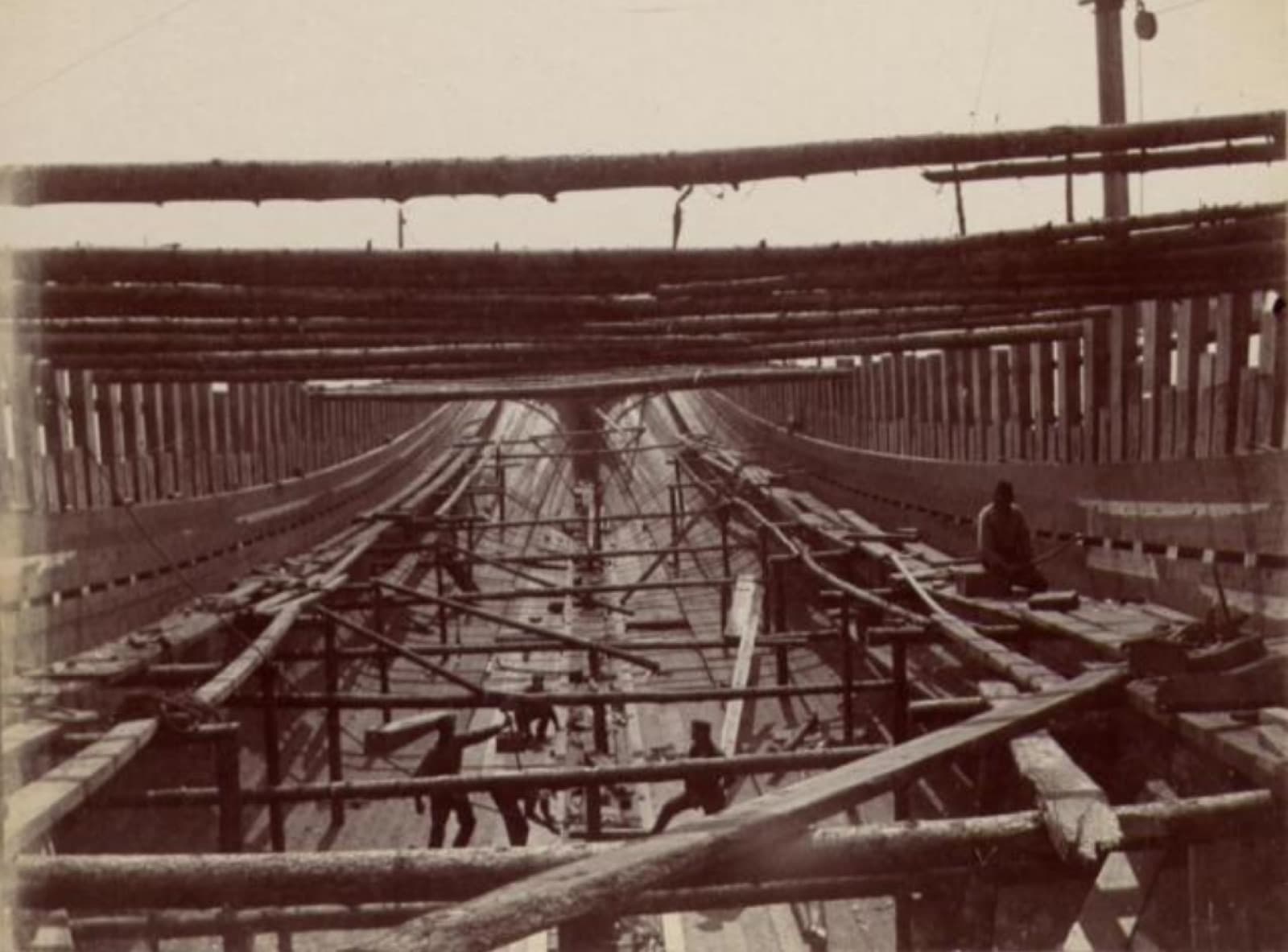 A large wooden vessel under construction in the Clark yard, ribs and staging in place.